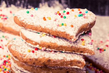 Biscuits strewed by powdered sugar and multicolor decorations