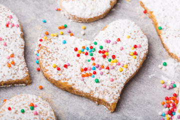 Biscuits strewed by powdered sugar and multicolor decorations