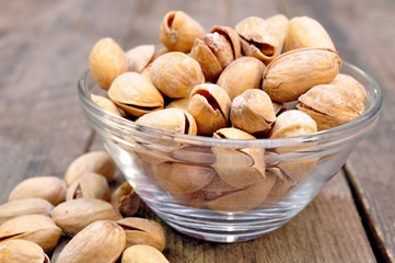 pistachios into a bowl on the table