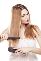 redheaded girl straightens the hair using a hair straightener