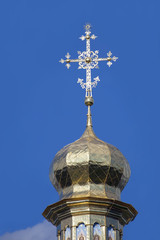 Fototapeta na wymiar Gilded cupola and cross of Caves Monastery in Kiev.