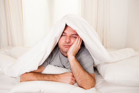 Man In Bed  Suffering Insomnia And Sleep Disorder