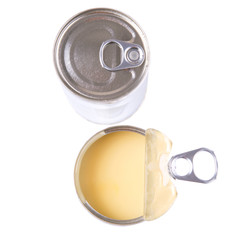 Condensed milk in tin cans over white background