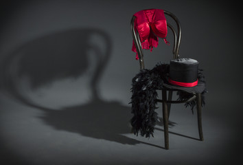 On retro chair is a cabaret dancer clothing. - obrazy, fototapety, plakaty