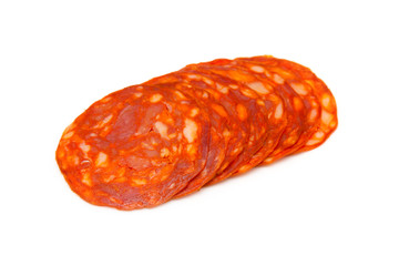 Sliced chorizo sausage isolated on a white studio background.