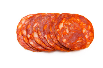 Sliced chorizo sausage isolated on a white studio background. - obrazy, fototapety, plakaty