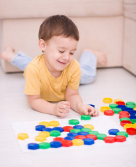Boy is playing with building blocks