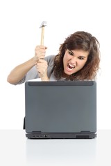 Angry woman ready to destroy a computer with a hammer