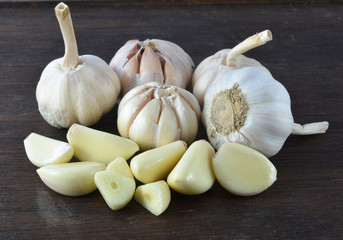 Organic garlic whole and cloves on the wooden background