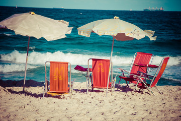 Beach chairs and umbrella on beach in Rio de Janeiro