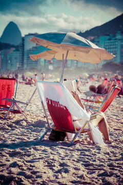 Beach chairs and umbrella on beach in Rio de Janeiro