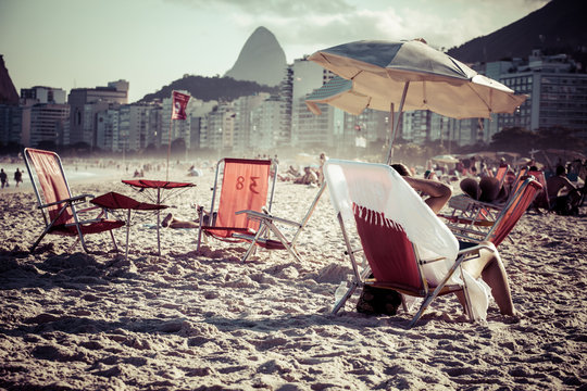 Beach chairs and umbrella on beach in Rio de Janeiro