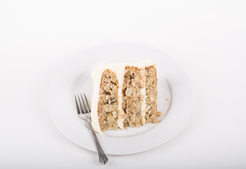 Slice of Hummingbird Cake on White Plate with Fork.