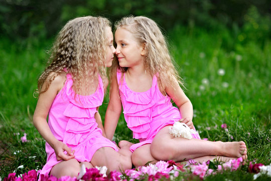 portrait of two twins with peonies