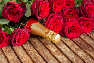 crimson  red  roses with neck of champagne