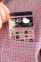 Smartphone with a transparent screen in a shirt pocket.