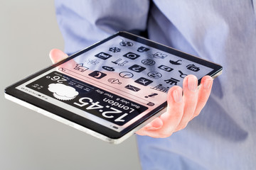 Tablet with transparent screen in human hands.