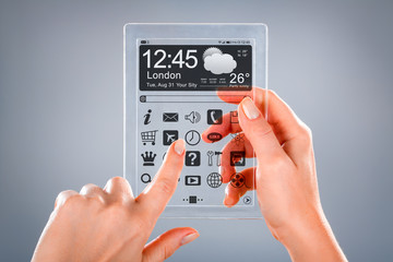 Tablet with transparent screen in human hands.
