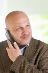Portrait of a businessman with a mobile phone.