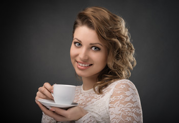 Portrait of young  girl brown hair drinking coffee