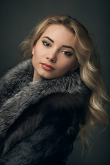 Portrait of young  girl, blonde  in fur coat