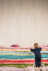Child climbs on the bed - Princess and the Pea.