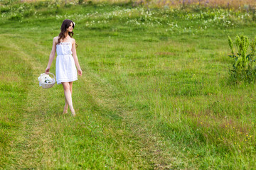 Young beautiful woman in a summer field