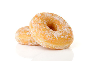 Two stacked sugared donuts over white background