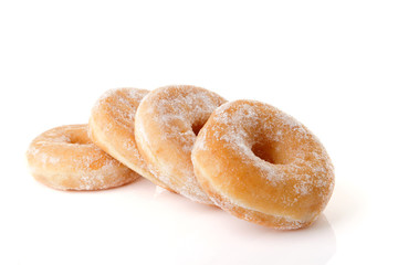 Four stacked sugared donuts over white background