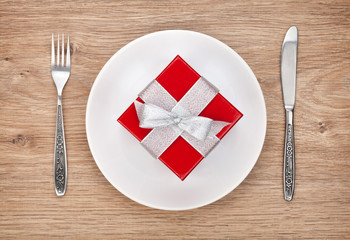 Valentine's day gift box on plate and silverware