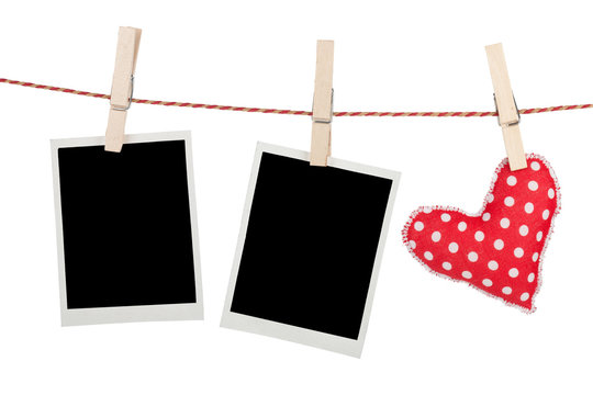 Blank instant photos and red heart hanging