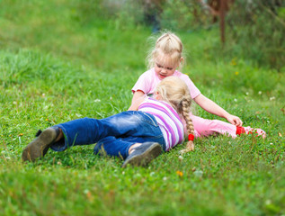 Fototapeta premium two girls playing on the green grass