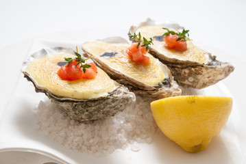 oysters with sauce and lemon on plate