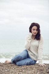 Fototapeta na wymiar girl sitting on the seashore