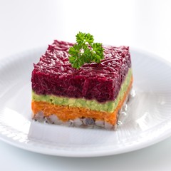 Appetiser with herring, beetroot, carrot and avocado