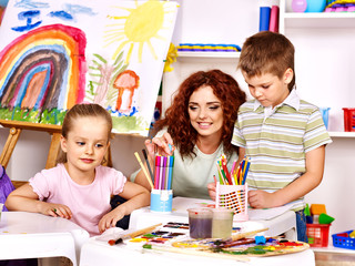 Child painting at easel.