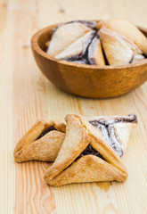 Hamantaschen cookies for Purim on a wooden surface