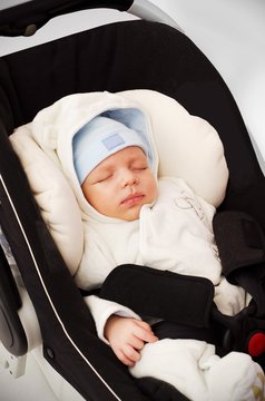 Little baby boy sleeping in car seat