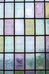 colored glass window with regular block pattern blue green tone