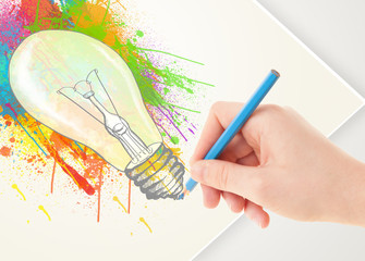 Hand drawing on paper a colorful splatter lightbulb