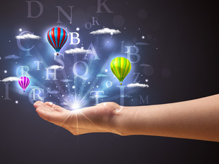 Letters and balloons in the hand of a woman