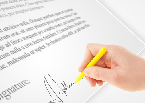 Hand writing personal signature on a paper form