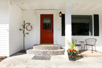 White classic porch with a red wooden door