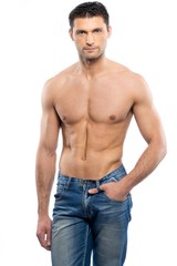 Fototapeta premium Handsome young man in blue jeans with naked torso