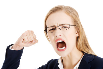 Furious angry business woman trying to punch you.