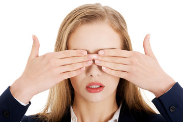 Beautiful business woman covering her eyes.