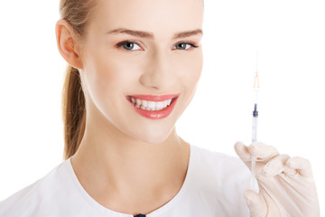 Beautiful young nurse with needle.