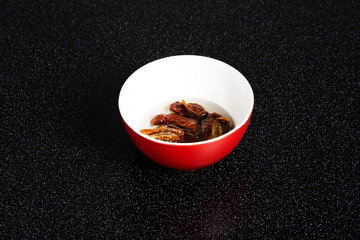 Dry mashroom put in a bowl with water.