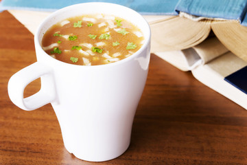 Hot vegetable soup in a cup.