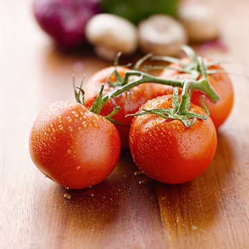 fresh tomatoes on cutting board